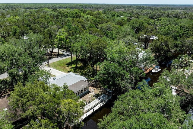 aerial view of property's location featuring a forest