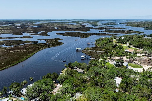 aerial view of property's location with a large body of water