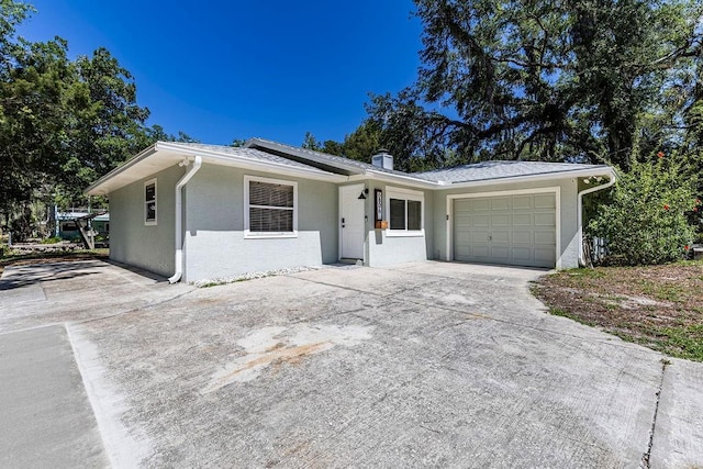 ranch-style home with driveway and a garage