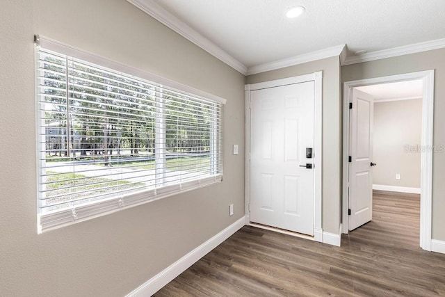 foyer with dark wood-style floors, baseboards, and ornamental molding