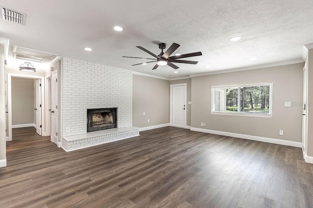 unfurnished living room with a ceiling fan, dark wood-type flooring, crown molding, baseboards, and a fireplace
