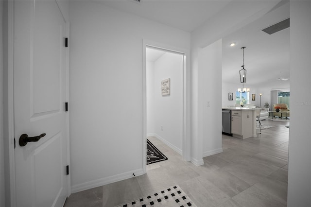 4451 Elijah Loop, The Villages, FL 32163 - hallway with baseboards and a chandelier