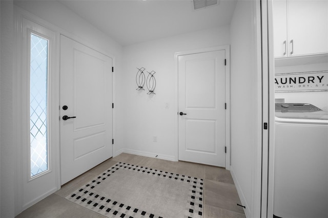 4451 Elijah Loop, The Villages, FL 32163 - foyer with washer / dryer, light tile patterned flooring, and baseboards