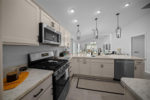 4451 Elijah Loop, The Villages, FL 32163 - kitchen featuring stainless steel appliances, a sink, lofted ceiling, a peninsula, and light stone counters