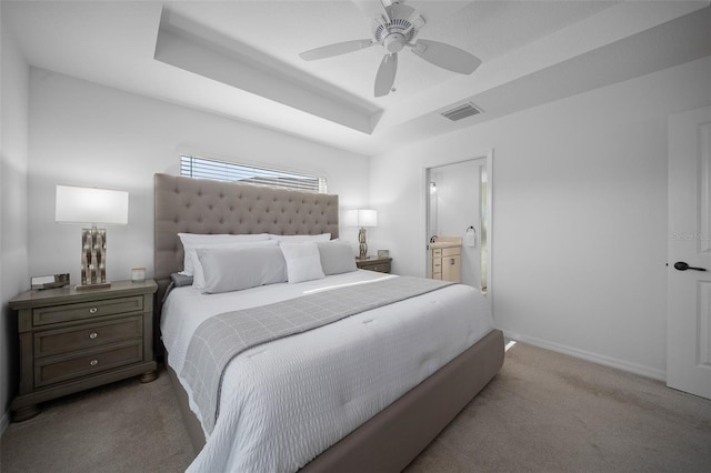 4451 Elijah Loop, The Villages, FL 32163 - bedroom featuring carpet flooring, a raised ceiling, baseboards, and connected bathroom
