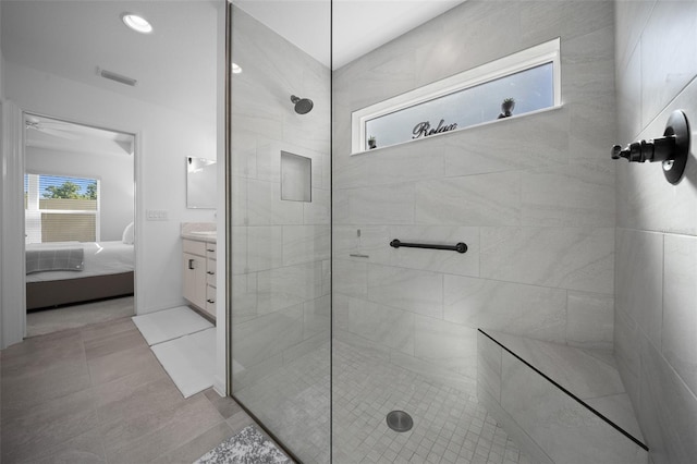 4451 Elijah Loop, The Villages, FL 32163 - ensuite bathroom featuring vanity, walk in shower, tile patterned flooring, and a ceiling fan