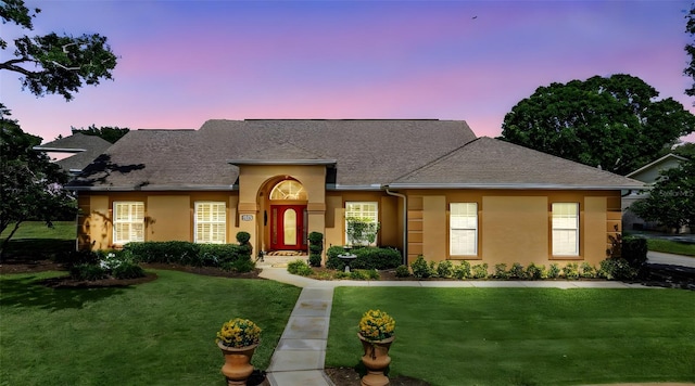 34021 Park Ln, Leesburg, FL 34788 - view of front of property featuring a lawn, stucco siding, and a shingled roof