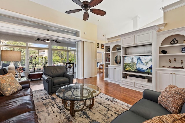 34021 Park Ln, Leesburg, FL 34788 - living area featuring a ceiling fan, wood finished floors, built in shelves, and a towering ceiling