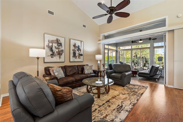 34021 Park Ln, Leesburg, FL 34788 - living room with a ceiling fan, wood finished floors, high vaulted ceiling, and baseboards