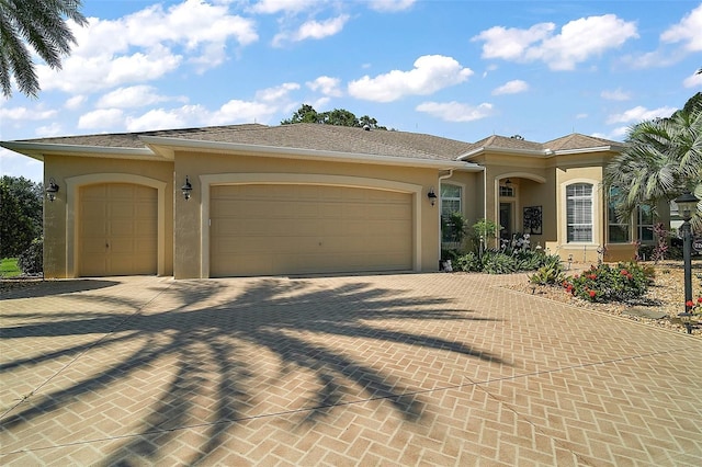 2204 Baypoint Way, The Villages, FL 32162 - mediterranean / spanish house featuring stucco siding, a garage, and decorative driveway