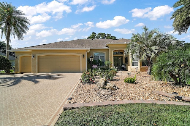 2204 Baypoint Way, The Villages, FL 32162 - view of front of house with stucco siding, an attached garage, and driveway