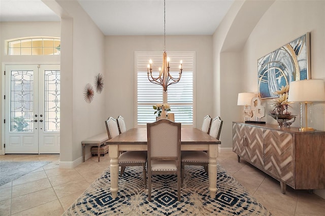 2204 Baypoint Way, The Villages, FL 32162 - dining area with a chandelier, light tile patterned flooring, french doors, and baseboards