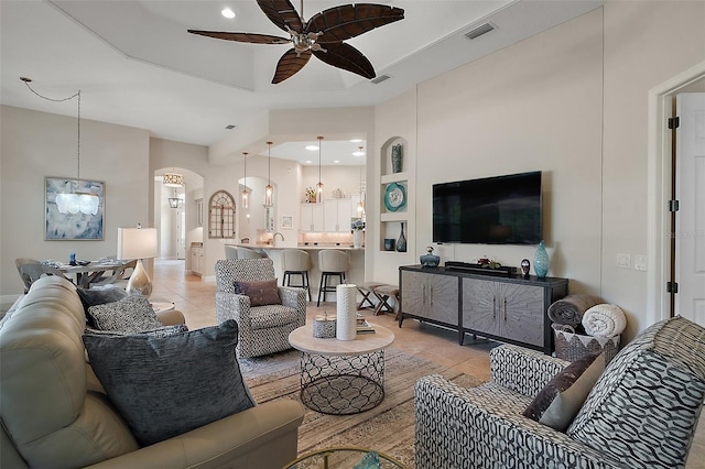 2204 Baypoint Way, The Villages, FL 32162 - living area featuring ceiling fan, light tile patterned floors, arched walkways, and recessed lighting