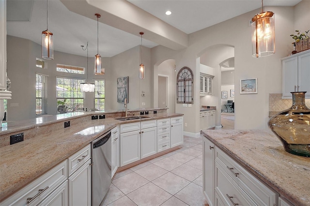 2204 Baypoint Way, The Villages, FL 32162 - kitchen featuring dishwasher, a sink, arched walkways, light tile patterned floors, and white cabinets