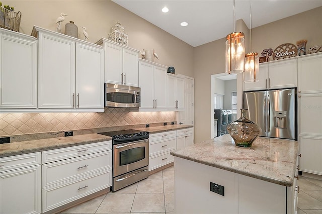2204 Baypoint Way, The Villages, FL 32162 - kitchen with appliances with stainless steel finishes, tasteful backsplash, a center island, light tile patterned flooring, and recessed lighting