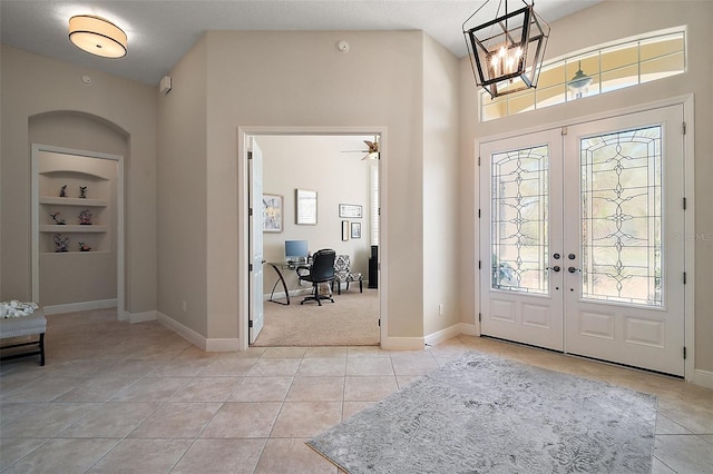 2204 Baypoint Way, The Villages, FL 32162 - entrance foyer featuring french doors, light tile patterned floors, a chandelier, baseboards, and light carpet