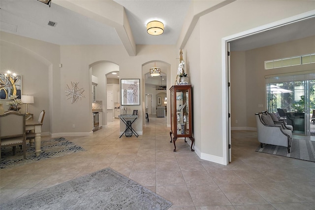 2204 Baypoint Way, The Villages, FL 32162 - entryway with arched walkways, light tile patterned floors, baseboards, and beam ceiling