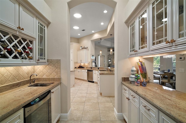 2204 Baypoint Way, The Villages, FL 32162 - kitchen with a sink, light stone countertops, light tile patterned floors, backsplash, and recessed lighting
