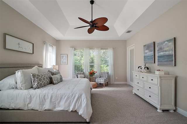 2204 Baypoint Way, The Villages, FL 32162 - bedroom featuring multiple windows, a raised ceiling, light colored carpet, and baseboards