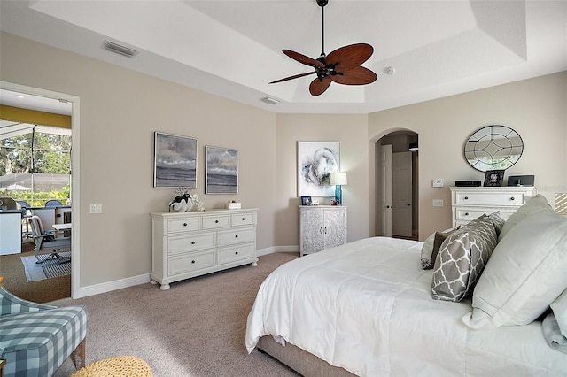 2204 Baypoint Way, The Villages, FL 32162 - bedroom with carpet, arched walkways, a raised ceiling, and baseboards