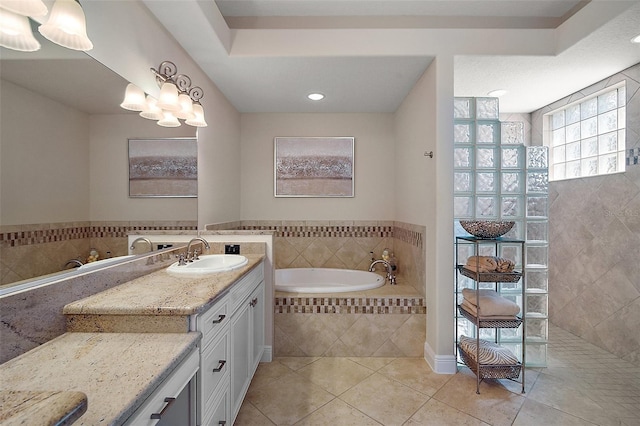 2204 Baypoint Way, The Villages, FL 32162 - bathroom with tile patterned floors, a garden tub, a walk in shower, vanity, and recessed lighting