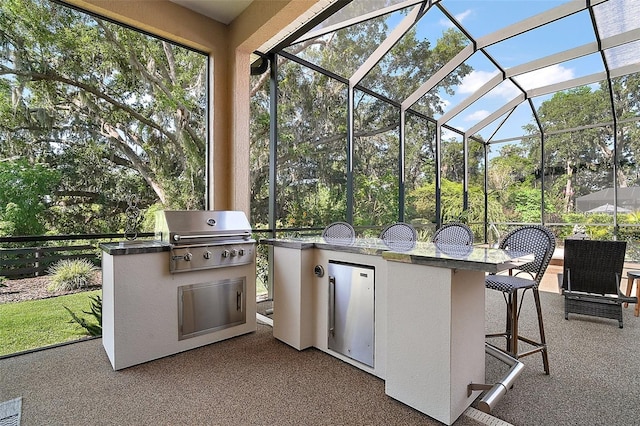 2204 Baypoint Way, The Villages, FL 32162 - view of patio / terrace featuring an outdoor kitchen, a grill, and a lanai