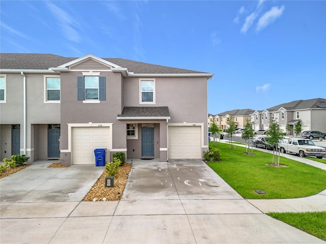1042 Lido Dr, Howey In The Hills, FL 34737 - view of front of property featuring a residential view, driveway, an attached garage, stucco siding, and a front lawn