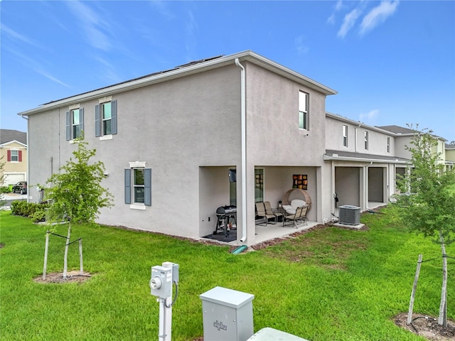 1042 Lido Dr, Howey In The Hills, FL 34737 - rear view of property with stucco siding, a patio, central air condition unit, and a yard