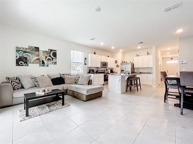 1042 Lido Dr, Howey In The Hills, FL 34737 - living room with light tile patterned floors and recessed lighting