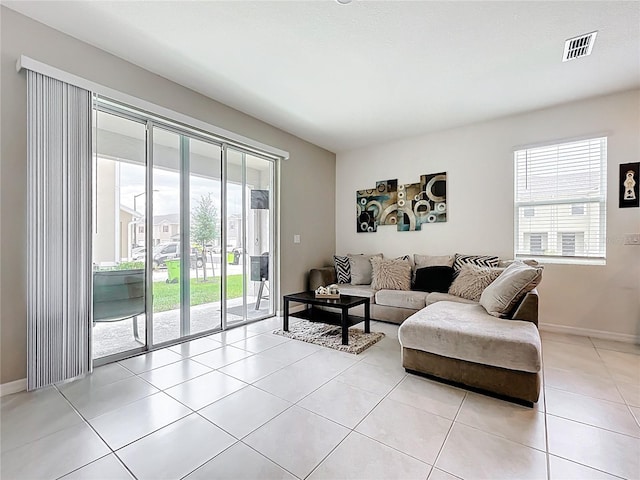 1042 Lido Dr, Howey In The Hills, FL 34737 - living area with healthy amount of natural light, light tile patterned floors, and baseboards