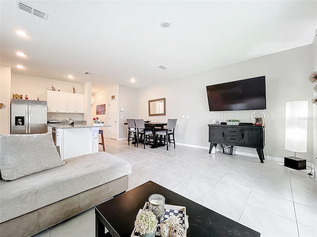 1042 Lido Dr, Howey In The Hills, FL 34737 - living area with light tile patterned floors, baseboards, and recessed lighting
