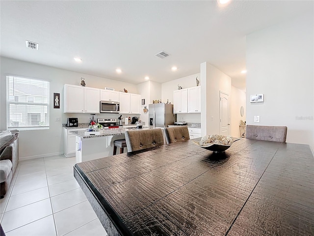 1042 Lido Dr, Howey In The Hills, FL 34737 - dining space with light tile patterned floors, baseboards, and recessed lighting