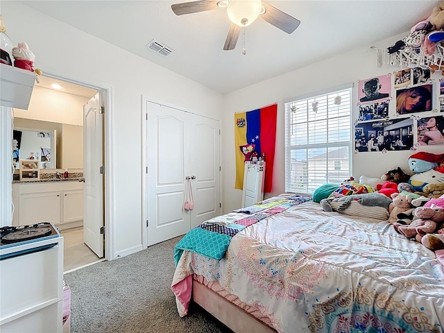1042 Lido Dr, Howey In The Hills, FL 34737 - bedroom featuring light carpet, ensuite bathroom, a ceiling fan, a closet, and baseboards
