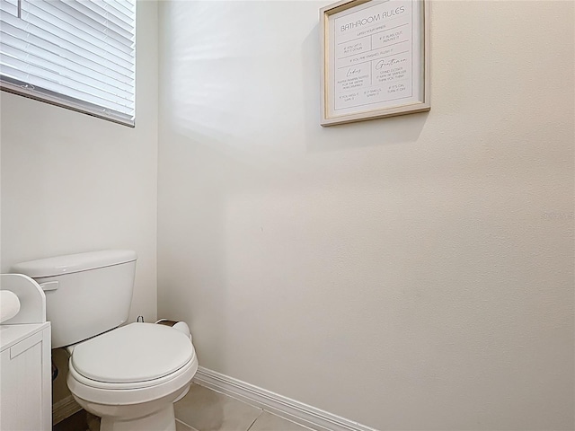 1042 Lido Dr, Howey In The Hills, FL 34737 - bathroom featuring tile patterned flooring, toilet, and baseboards