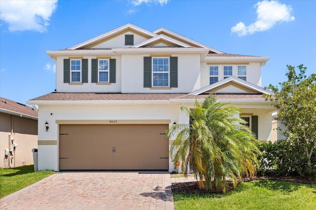 4869 Grassendale Ter, Sanford, FL 32771 - view of front facade featuring stucco siding, a garage, decorative driveway, and a shingled roof
