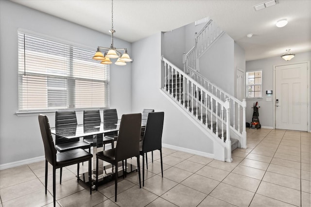 4869 Grassendale Ter, Sanford, FL 32771 - tiled dining space featuring stairs, a chandelier, and baseboards