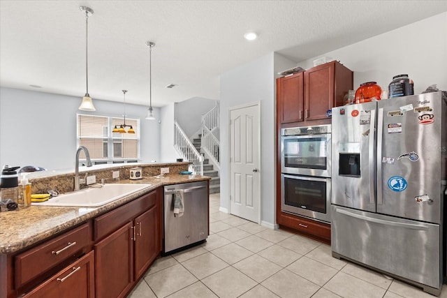 4869 Grassendale Ter, Sanford, FL 32771 - kitchen with stainless steel appliances, a sink, decorative light fixtures, and light tile patterned floors