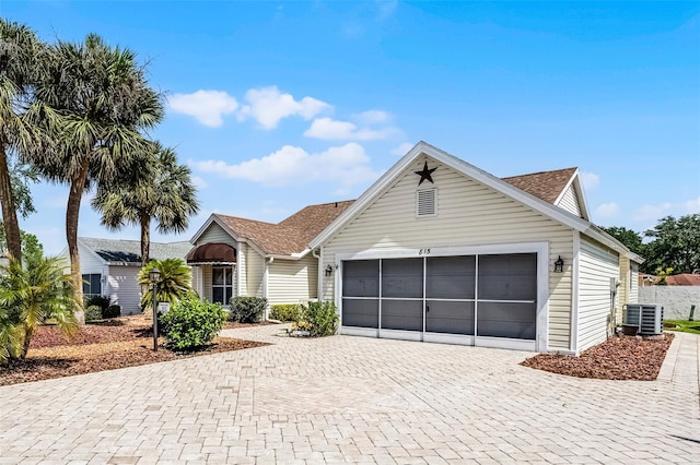 815 Cortez Ave, The Villages, FL 32159 - ranch-style house with decorative driveway, an attached garage, and roof with shingles