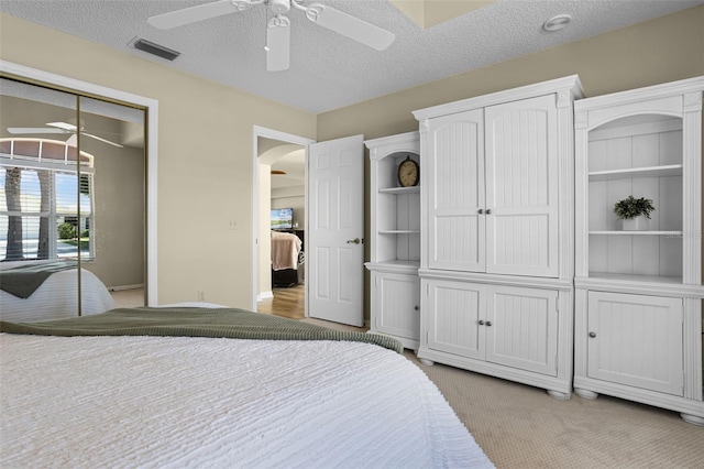 815 Cortez Ave, The Villages, FL 32159 - bedroom with arched walkways, ceiling fan, a textured ceiling, light colored carpet, and multiple closets
