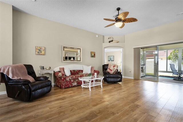 815 Cortez Ave, The Villages, FL 32159 - living room featuring wood finished floors, a ceiling fan, and a textured ceiling