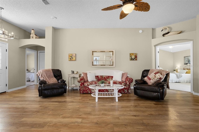 815 Cortez Ave, The Villages, FL 32159 - living room with arched walkways, ceiling fan, wood finished floors, and a textured ceiling