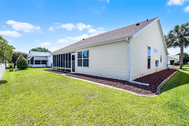 815 Cortez Ave, The Villages, FL 32159 - back of property featuring a sunroom, a lawn, and roof with shingles