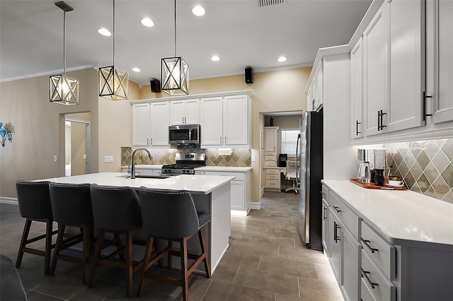6243 Danielson Loop, The Villages, FL 32163 - kitchen with stainless steel appliances, a sink, backsplash, a breakfast bar, and ornamental molding