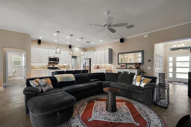 6243 Danielson Loop, The Villages, FL 32163 - living room with ceiling fan, a chandelier, ornamental molding, and recessed lighting