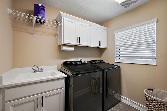 6243 Danielson Loop, The Villages, FL 32163 - laundry room with separate washer and dryer, cabinet space, and baseboards