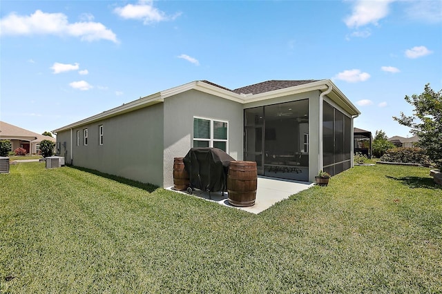 6243 Danielson Loop, The Villages, FL 32163 - back of property with a sunroom, a yard, stucco siding, and cooling unit