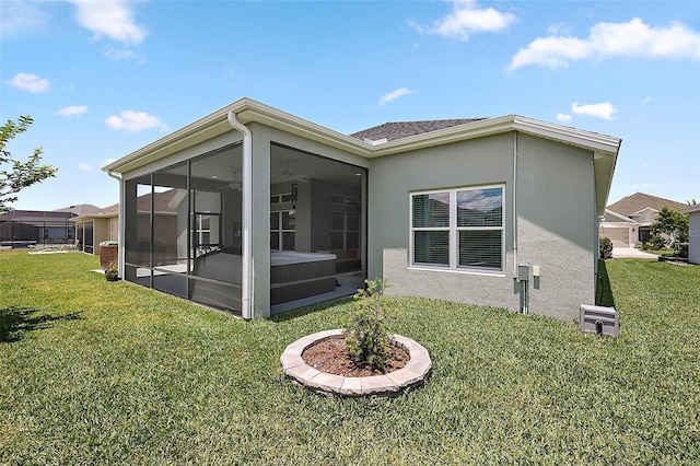6243 Danielson Loop, The Villages, FL 32163 - back of house with a sunroom, a yard, and stucco siding