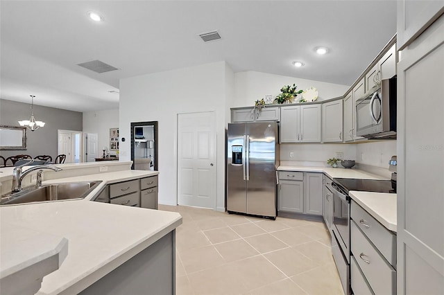 11287 Stewart Loop, Oxford, FL 34484 - kitchen with stainless steel appliances, gray cabinets, a sink, a chandelier, and light countertops