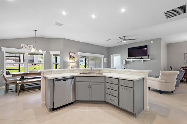 11287 Stewart Loop, Oxford, FL 34484 - kitchen with stainless steel dishwasher, gray cabinetry, a sink, open floor plan, and vaulted ceiling