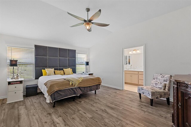 11287 Stewart Loop, Oxford, FL 34484 - bedroom featuring multiple windows, wood finished floors, vaulted ceiling, and a sink